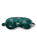 Experience luxurious slumber with the Adults Silk Sleep Mask in Panthère de Luxe by Petite Plume, featuring detailed white leopard sketches on a green backdrop. It includes an elastic strap and a small white tag for added comfort.