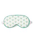 The Petite Plume Adults Sleep Mask in Match Point showcases a tennis print with green rackets and yellow balls, complete with green trim and an adjustable white strap. Pair it with matching pajamas for a chic set. The brand label adds a touch of elegance to the side.