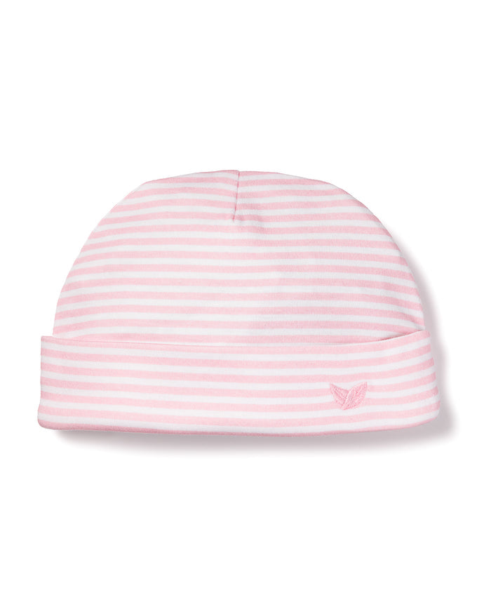 The Babys Pima Hat in Pink Stripes by Petite Plume is a pink and white striped baby hat made from soft Peruvian Pima Cotton, featuring an embroidered emblem on the folded rim, making it ideal for infants.