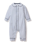 The Babys Twill Cambridge Romper by Petite Plume is crafted from soft brushed twill, perfect for sleepwear. It features long sleeves, a collar, and vertical navy stripes. Front buttons add style, while solid blue bands at the cuffs ensure cozy elegance for your little one.