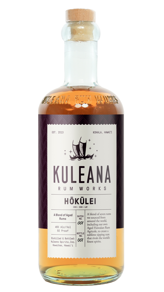 A bottle of Kuleana Rum Works Hóküliéi rum on a plain white background. The clear glass bottle shows the amber-colored liquid inside, topped with a light brown cork.
