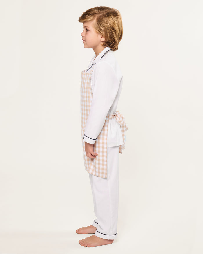 The Kid's Twill Apron in Camel Gingham, featuring a beige and white gingham pattern, two front pockets, and long waist ties, is displayed on a white background.