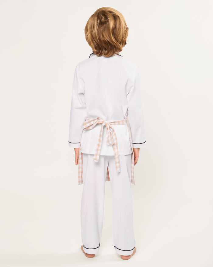 The Kid's Twill Apron in Camel Gingham, featuring a beige and white gingham pattern, two front pockets, and long waist ties, is displayed on a white background.