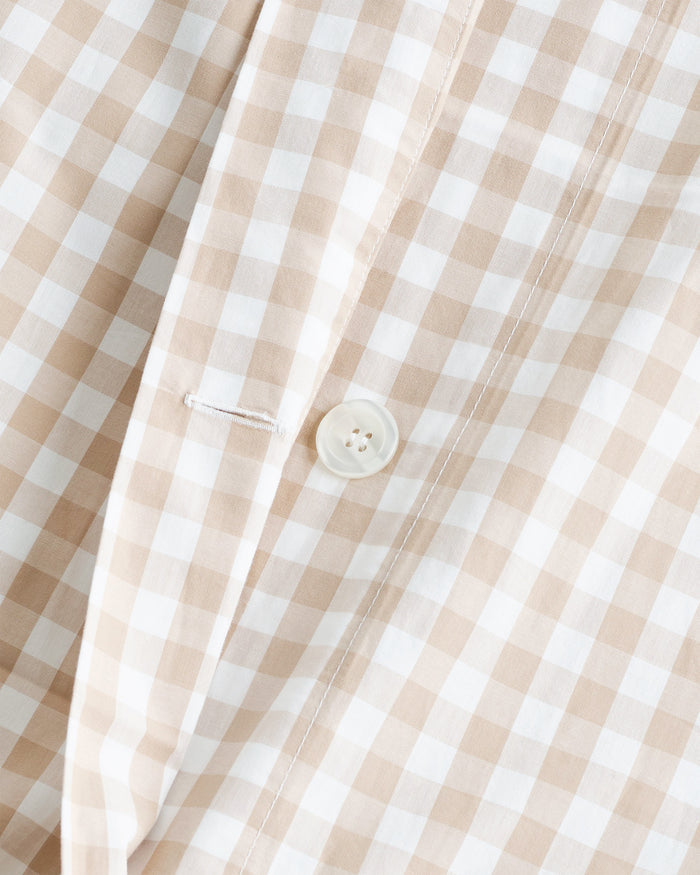The Luxe Premium Percale Duvet Set in Camel Gingham features two pillows and a folded comforter with a beige and white gingham check pattern, neatly stacked on a white background.