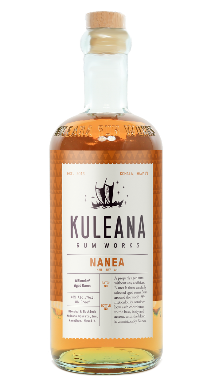 A bottle of Kuleana Rum Works Nanea rum with amber liquid, a white label, and a cork stopper, shown on a plain white background.