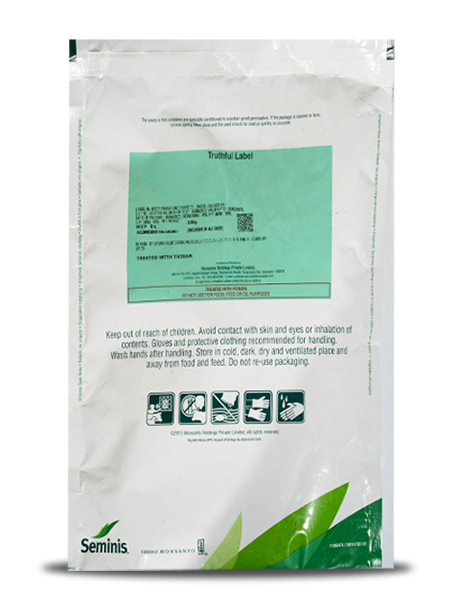 Back view of a Seminis seed pouch showing a green Truthful Label, caution text, and safety pictograms.