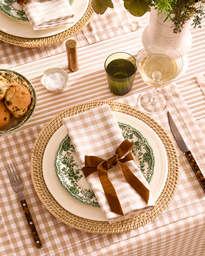 A neatly folded set of Signature Twill Napkins in a camel and white gingham checkered pattern, displayed on a white background.