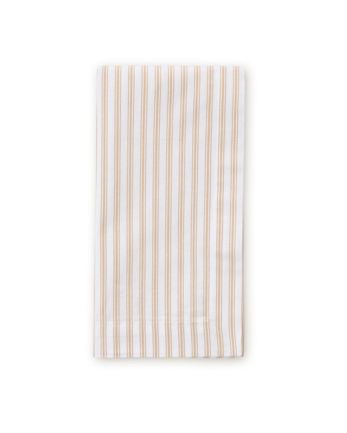 A neatly folded stack of Signature Twill Napkins in Camel Ticking, featuring thin beige and white stripes, displayed against a white background.