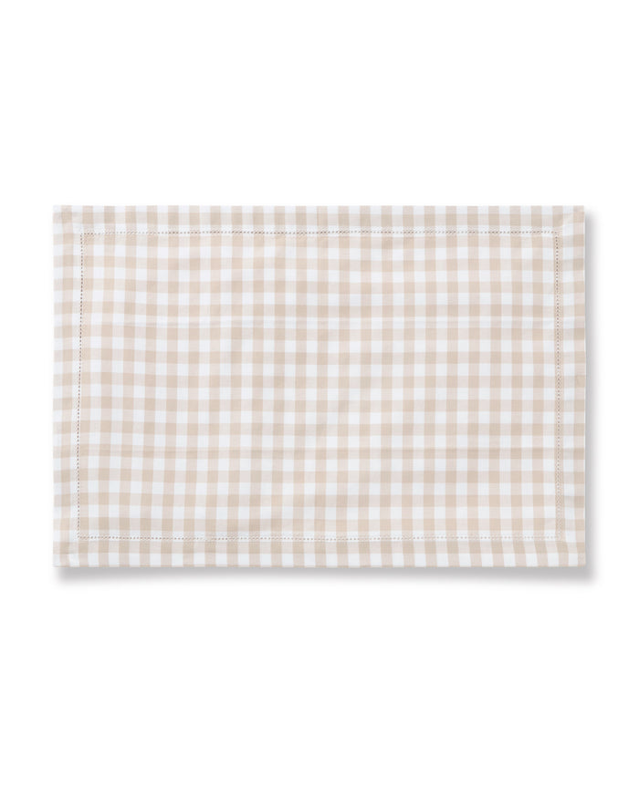 The Signature Twill Placemats in Camel Gingham feature a rectangular shape, beige and white gingham check pattern, and neatly hemmed edges, shown against a plain white background.