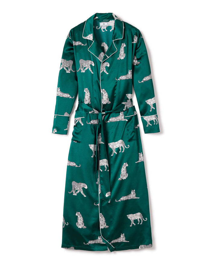 The Womens Silk Long Robe in Panthère de Luxe by Petite Plume is made from mulberry silk with a white panther print. It features a shawl collar, long sleeves, a matching belt at the waist, and elegant edges highlighted by contrasting white piping.