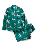 Discover elegance with the Womens Silk Pajama Set in Panthère de Luxe by Petite Plume, featuring a green long-sleeved button-up shirt and pants adorned with white panther illustrations for exquisite relaxation.