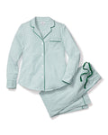 A stack of Petite Plumes Womens Twill Pajama Sets in Emerald Ticking showcases moisture-wicking fabric: the top has green clovers, the second is solid green, the third is white with green trim, and the bottom features bold green and white stripes.
