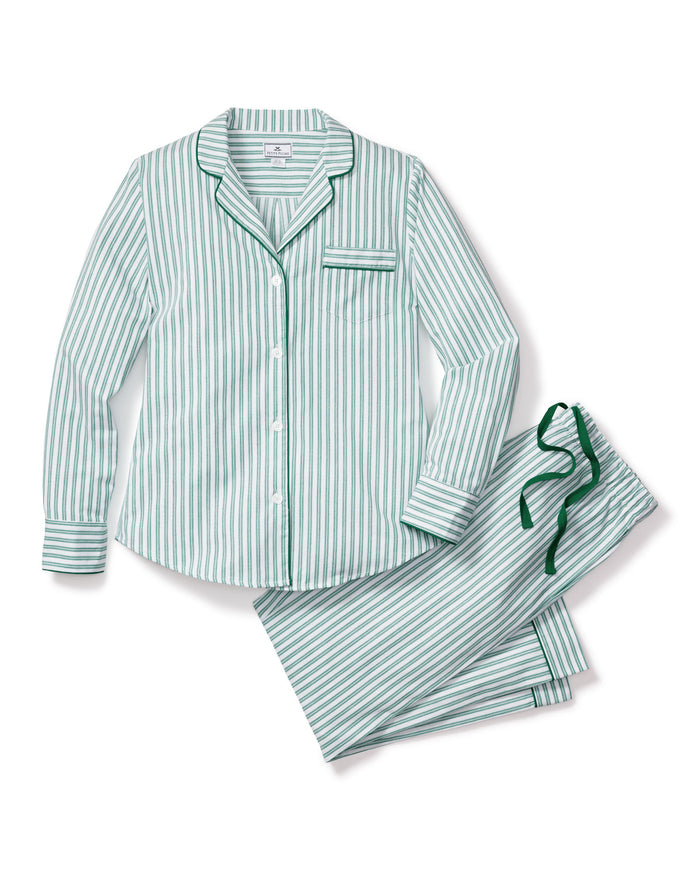 A stack of Petite Plumes Womens Twill Pajama Sets in Emerald Ticking showcases moisture-wicking fabric: the top has green clovers, the second is solid green, the third is white with green trim, and the bottom features bold green and white stripes.