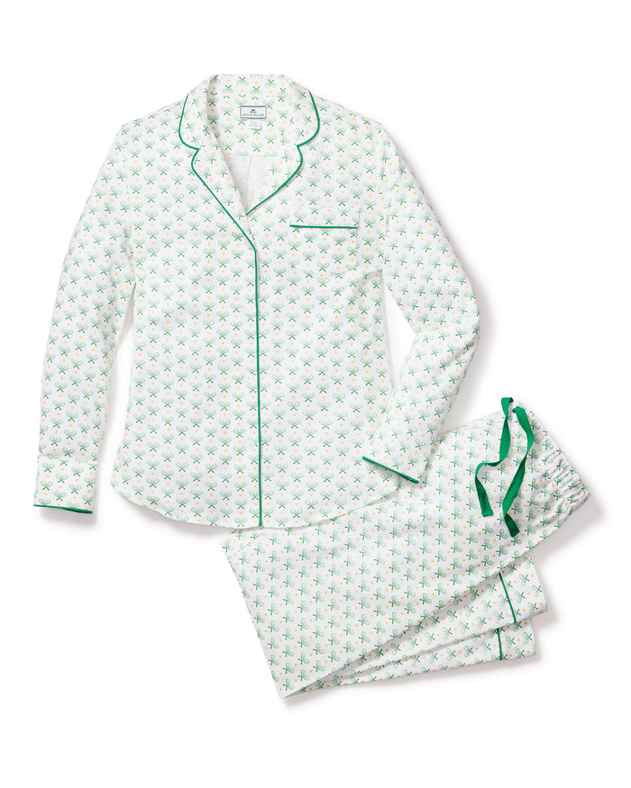 The Womens Twill Pajama Set in Match Point by Petite Plume features high-quality cotton with a white base and small green floral pattern. The collared top includes a single chest pocket with green piping, while the pants feature a drawstring, all presented on a light background.