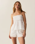 A woman with wavy, light brown hair wears the Women's Voile Luna Cami Short Set in White, standing against a plain light background.