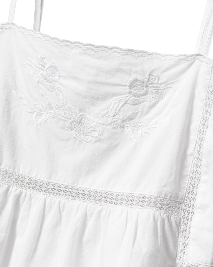 A woman with wavy, light brown hair wears the Women's Voile Luna Cami Short Set in White, standing against a plain light background.