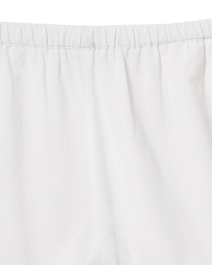 A woman with wavy, light brown hair wears the Women's Voile Luna Cami Short Set in White, standing against a plain light background.